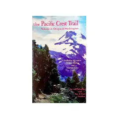 Guía del Pacific Crest Trail, volumen 2: Oregón y Washington. Senderistas se adentran en el bosque con vistas a montañas nevadas.