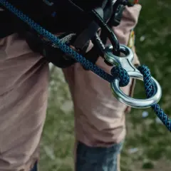 Detalle de equipo de escalada con varios tipos de cuerdas y mosquetones.